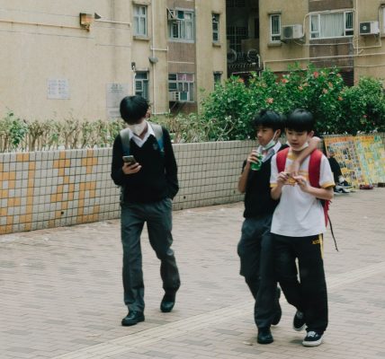 a group of young people walking down a street