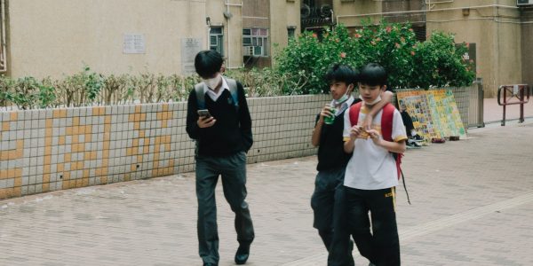 a group of young people walking down a street
