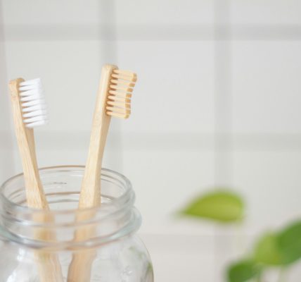 two toothbrush in mason jar