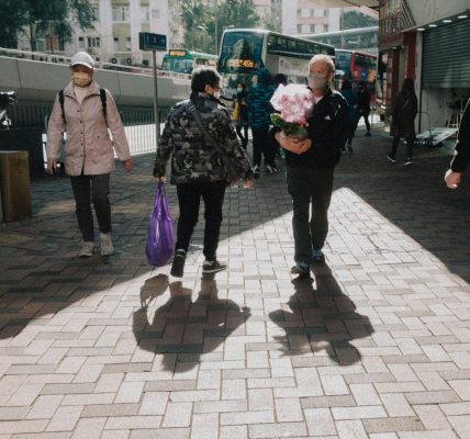 a group of people walking down a sidewalk