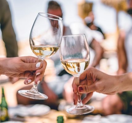 two women holding glass of champagnes