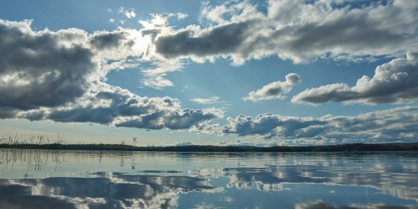 blue sky and white clouds over lake