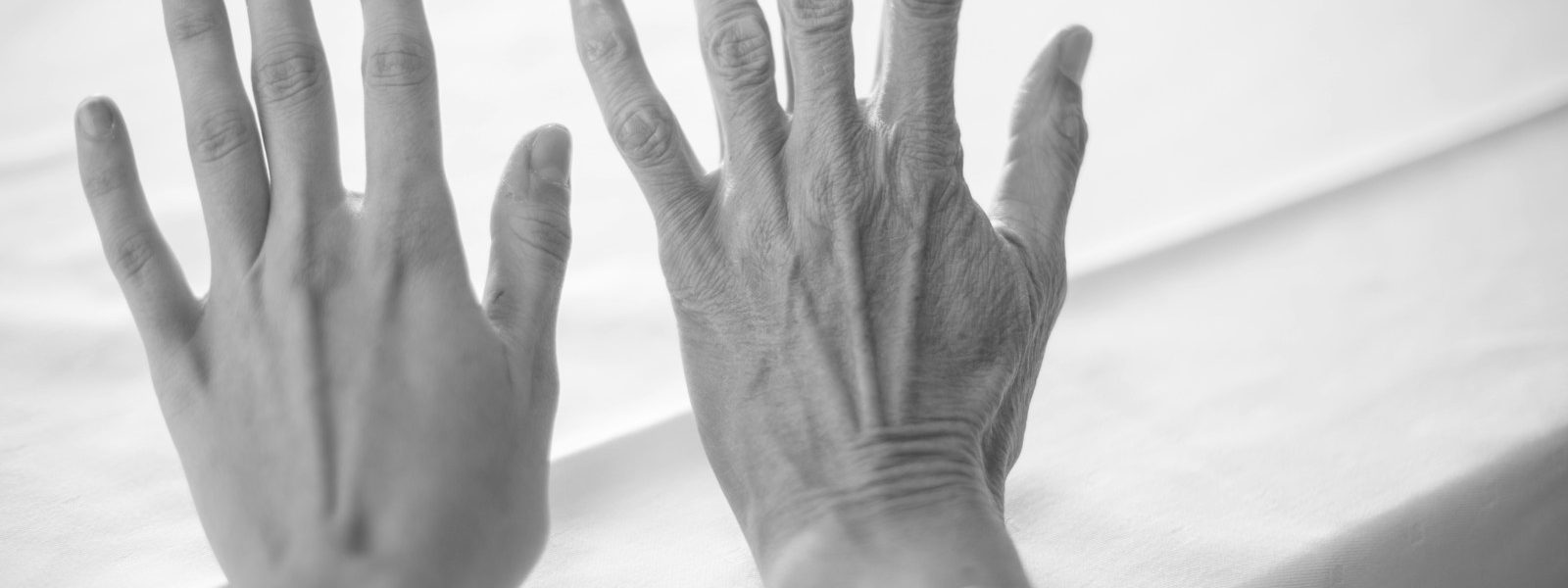 persons left hand on white textile