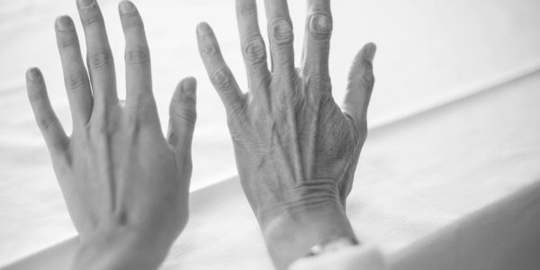 persons left hand on white textile