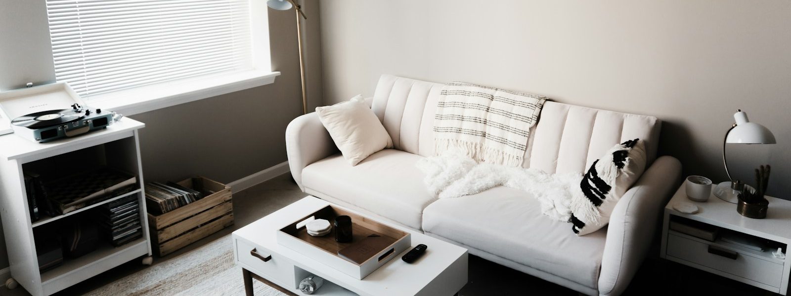 white couch in front of white wooden table