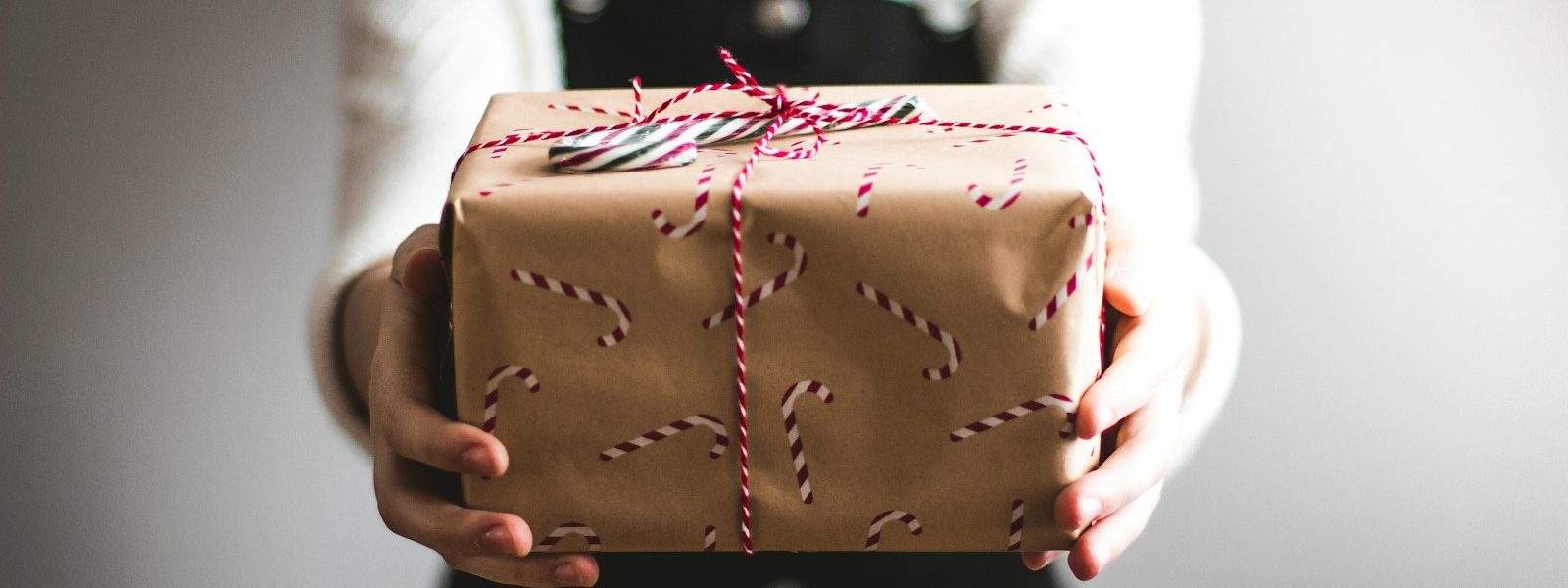 person showing brown gift box