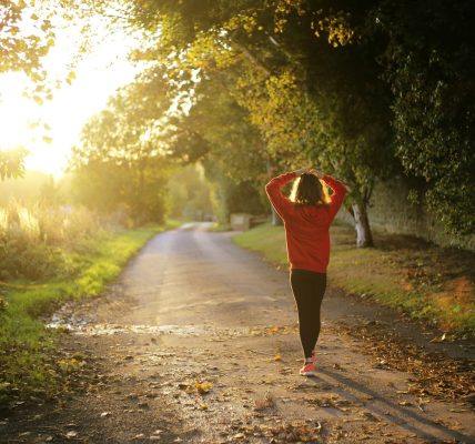 woman walking on pathway during daytime