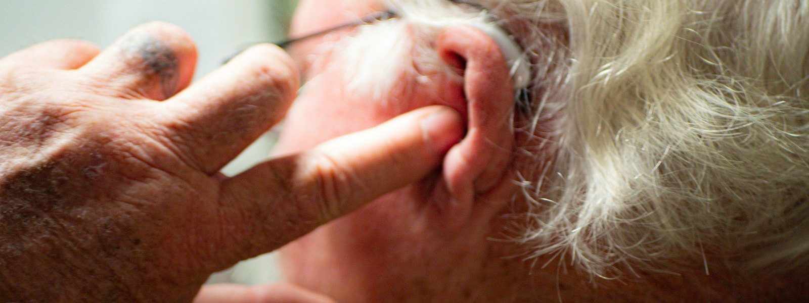 a man with his hand on his face