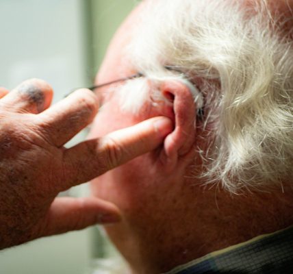 a man with his hand on his face