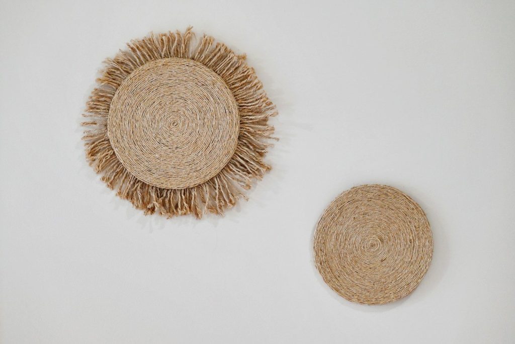 a straw hat and a round straw hat on a white background