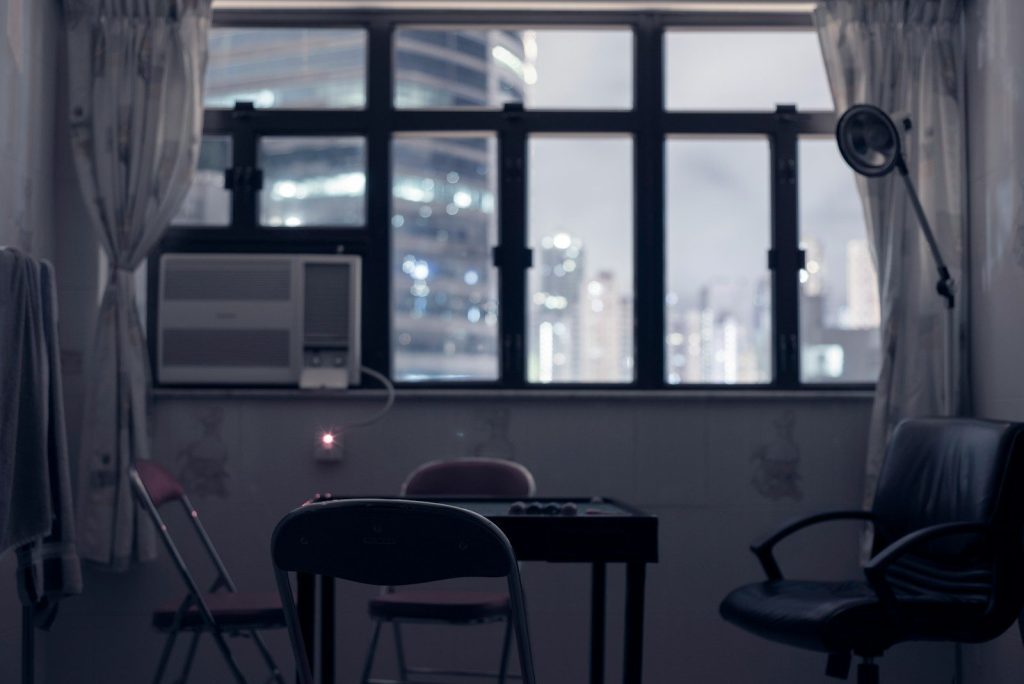 window-type AC unit near empty chairs and table
